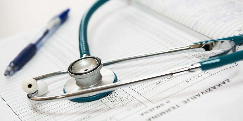 Stethoscope, patient card and pen